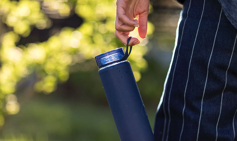 person holding water bottle